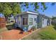 Charming home exterior showcasing a well-kept lawn, brick-lined walkway and potted plants at 7235 Maryland Ave, Hudson, FL 34667