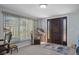 Bright foyer with a decorative front door, tile flooring, and a writing desk under the window at 7235 Maryland Ave, Hudson, FL 34667