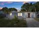 Charming home with well-maintained lawn, a lovely stone seating area, and a decorative front door at 7235 Maryland Ave, Hudson, FL 34667