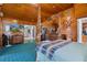 Cozy primary bedroom featuring wood-clad walls and ceiling plus an ornate four-poster bed and ensuite bath at 7235 Maryland Ave, Hudson, FL 34667