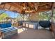Outdoor kitchen and seating area with built-in grill and counter space, perfect for entertaining at 7235 Maryland Ave, Hudson, FL 34667