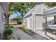 Backyard shed featuring horizontal siding and a well manicured walkway with lush landscaping at 7235 Maryland Ave, Hudson, FL 34667