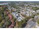 An aerial view of a suburban neighborhood with well-maintained homes and tree-lined streets at 7514 Rocky Point Dr, Hudson, FL 34667