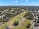 Scenic aerial view of a lush golf course with surrounding homes under a bright sky at 7514 Rocky Point Dr, Hudson, FL 34667