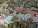 Aerial view showcasing community amenities, including a pool, tennis courts, and recreational areas at 7514 Rocky Point Dr, Hudson, FL 34667