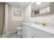 Bright bathroom with white vanity, marble countertop, and shower with tile surround at 7514 Rocky Point Dr, Hudson, FL 34667