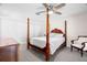 Bedroom featuring a four-poster bed, carpet flooring, and ample closet space at 7514 Rocky Point Dr, Hudson, FL 34667