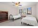 Cozy bedroom featuring two twin beds, a window with blinds, and neutral carpet at 7514 Rocky Point Dr, Hudson, FL 34667