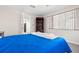 Bright bedroom with a window, a bookcase, and a glimpse of the kitchen at 7514 Rocky Point Dr, Hudson, FL 34667