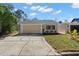 Charming home with a two-car garage, manicured lawn, and attractive landscaping at 7514 Rocky Point Dr, Hudson, FL 34667