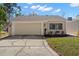 Charming home features an attached garage, neutral paint, manicured lawn and a sidewalk leading to the front door at 7514 Rocky Point Dr, Hudson, FL 34667