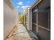 Narrow walkway between two buildings with stucco walls and a glimpse of foliage at 7514 Rocky Point Dr, Hudson, FL 34667