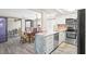 Stylish kitchen with stainless steel appliances, white cabinets, marble countertops, and open dining area with patio access at 7514 Rocky Point Dr, Hudson, FL 34667