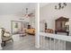 Bright living room featuring vaulted ceilings, a large ceiling fan, and sliding glass doors leading to the patio at 7514 Rocky Point Dr, Hudson, FL 34667