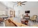 Bright living room with vaulted ceilings, gray wood floors, elegant furnishings, and plenty of natural light at 7514 Rocky Point Dr, Hudson, FL 34667