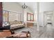 Bright living room with vaulted ceilings, gray wood floors, elegant furnishings, and plenty of natural light at 7514 Rocky Point Dr, Hudson, FL 34667