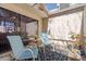 Enclosed patio area with seating, a small table, and a view of foliage and sunlight at 7514 Rocky Point Dr, Hudson, FL 34667