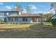 A home's backyard with a screened-in porch and lush lawn, perfect for outdoor relaxation at 7546 St Andrews Blvd, Weeki Wachee, FL 34613