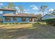 A home's backyard featuring a well-maintained lawn and a screened-in porch for cozy outdoor living at 7546 St Andrews Blvd, Weeki Wachee, FL 34613