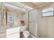 Bathroom with a glass door shower, a sink, and a large mirror for a spacious feel at 7546 St Andrews Blvd, Weeki Wachee, FL 34613