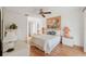 Bright bedroom with hardwood floors features a ceiling fan and white walls at 7546 St Andrews Blvd, Weeki Wachee, FL 34613