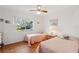 Bedroom featuring two twin beds, a window, and a ceiling fan at 7546 St Andrews Blvd, Weeki Wachee, FL 34613