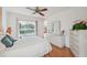 Bright bedroom featuring hardwood floors, a ceiling fan, and a sliding glass door to the outside at 7546 St Andrews Blvd, Weeki Wachee, FL 34613