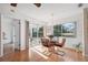 Bright dining area with hardwood floors features a chandelier and views of the outdoors at 7546 St Andrews Blvd, Weeki Wachee, FL 34613