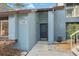 Inviting entrance of blue townhouse showcasing house number and mature landscaping at 7546 St Andrews Blvd, Weeki Wachee, FL 34613