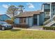 Exterior view of home featuring two stories, a well-maintained lawn, and a car in the driveway at 7546 St Andrews Blvd, Weeki Wachee, FL 34613