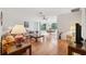 Bright living room with hardwood floors and large windows and access to dining area at 7546 St Andrews Blvd, Weeki Wachee, FL 34613