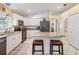 Stylish kitchen featuring white cabinets, granite countertops, stainless steel appliances, and central island at 7744 Craighurst Loop, New Port Richey, FL 34655