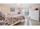 Bright bedroom featuring natural light, carpeted floors, and an elegant ceiling fan at 7744 Craighurst Loop, New Port Richey, FL 34655