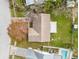 Aerial view of the home showcasing the backyard, including a swimming pool and outdoor lounging area at 7810 Putnam Cir, New Port Richey, FL 34655