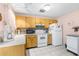 Efficient kitchen with white appliances, ample counter space, and tiled flooring at 7810 Putnam Cir, New Port Richey, FL 34655