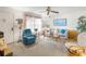 Cozy living room with comfortable seating, a ceiling fan, and natural light from the large window at 7810 Putnam Cir, New Port Richey, FL 34655