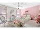 Bright bedroom with ceiling fan, decorative accents, and floral-patterned decor at 7810 Putnam Cir, New Port Richey, FL 34655