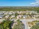 Aerial view of a residential neighborhood, with mature trees and well-maintained homes at 8447 Pavilion Dr, Hudson, FL 34667
