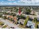 A bird's eye view of the neighborhood showcasing a variety of homes, landscaping, and nearby green spaces at 8447 Pavilion Dr, Hudson, FL 34667
