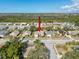 Community aerial shot shows lush green landscaping, mature trees, and neighborhood streets on a bright, sunny day at 8447 Pavilion Dr, Hudson, FL 34667
