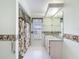 Bathroom with shower/tub and shower curtain, vanity, and tropical-themed decor at 8447 Pavilion Dr, Hudson, FL 34667