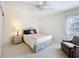Cozy bedroom with a twin bed, wicker nightstand, and a comfortable armchair at 8447 Pavilion Dr, Hudson, FL 34667