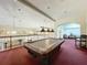 Billiard room on the second floor with a covered pool table and seating at 8447 Pavilion Dr, Hudson, FL 34667