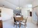Bright dining room features a wooden dining table with seating for four and chandelier lighting at 8447 Pavilion Dr, Hudson, FL 34667