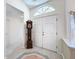 Foyer with double front doors, tile flooring, and a grandfather clock adjacent to the entry at 8447 Pavilion Dr, Hudson, FL 34667