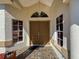 Inviting front entry features a double door entry, decorative lighting, and sidelight windows at 8447 Pavilion Dr, Hudson, FL 34667