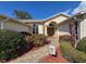 Close-up of home exterior showcasing a beautiful yard, walkway, and charming facade with front door at 8447 Pavilion Dr, Hudson, FL 34667