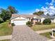 Charming single-story home features a manicured lawn, paved driveway, and attached two-car garage at 8447 Pavilion Dr, Hudson, FL 34667