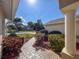 Front porch view showcasing a well-manicured walkway, beautiful landscaping, and a welcoming facade at 8447 Pavilion Dr, Hudson, FL 34667