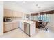 Bright kitchen with an island and an adjacent dining area with large windows at 8447 Pavilion Dr, Hudson, FL 34667